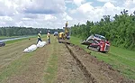 Workers dig a trench