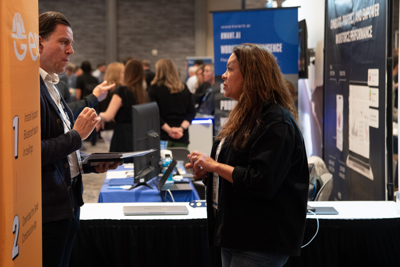 A discussion at an ENR FutureTech Exhibitor Booth