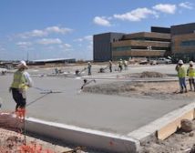 Construction workers spread concrete after it is poured on the site of the new Wilford Hall Ambulatory Surgical Centers west end parking lot