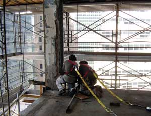 Workers installing safety cabling around the perimeter of the building in preparation for the deconstruction phase of the project. (Photo courtesy of Dormitory Authority of New York State)