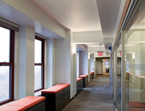 The design for Skanska USA’s space aimed to ensure maximum daylight exposure while also best utilizing long corridors that wrap around the Empire State Building’s large central elevator and utilities core. The result is a floor plan that has glass-walled interior offices facing exterior windows in the corridor, and the use of file cabinet-benches to make use of window-area bays.