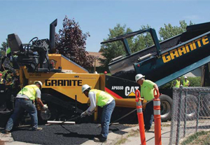 Granite Construction workers place warm-mix asphalt on a road project in Cottonwood Heights, Utah.
