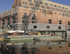  A barge-mounted crane lifts materials to the Accident Fund jobsite. Photo courtesy of Accident Fund Insurance Co. & The Christman Co.; Ike Lea, photographer. 