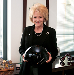 Motorcycler Peters holds helmet (Bottom) damaged in 2005 accident.