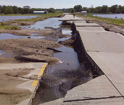 Rushing flood destroyed roads.