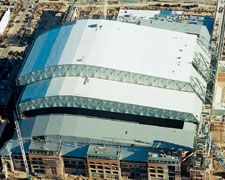 Colts stadium is first with panels sliding down pitched roof (left). Houston ballpark was first for Griffis-Silberman team.