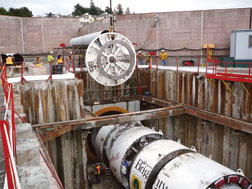 West tunnel TBM is fitted with cutter head. Tunnel segments are fitted with pipes in differing configurations.