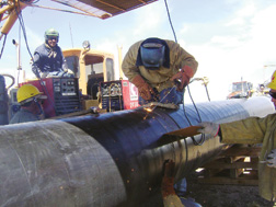Pipeline takes shape as crews weld steel-pipe sections in far-flung work sites.
