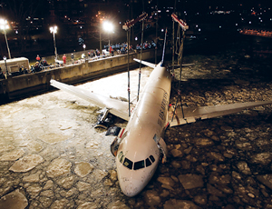 Plane was picked up intact from river (top) using large revolving marine cranes.