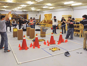 Some students fashioned a container to load wooden blocks, then carried it over the obstacles.