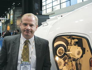 John Danner, Northern Power CEO, shows the Model 100B’s near-empty insides.