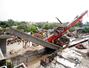 Launching girder was placing a concrete segment when pier cap failed beneath it.