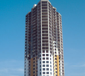 Tower core settled independently of stairwell core, which settled independently of tower perimeter, which settled independently of post-tensioned garage, causing at least 14 in. of differential settlement.