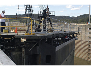 Workers rig a crippled gate in the Ohio river’s Markland Lock for removal. A mishap on Sept. 27 put the gate, scheduled for replacement in 2011, out of commission. Stimulus funding is helping the Corps push recovery by letting more parts of the lock rehabilitation program go off at once.