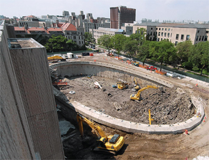 Oval-shaped glass dome will rest on a 120-ft by 240-ft slurry wall, initially drawn as a perfect oval. The foundation contractor proposed “facet” cuts due to equipment constraints.
