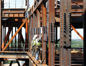 Steelworkers on the $1.77-billion National Geospatial-Intelligence Agency New Campus East project secure a 90-ton truss, 130 ft above the base.
