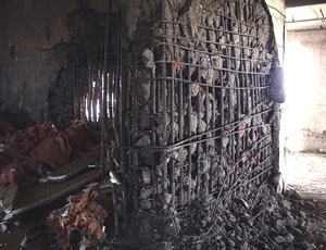 Walls were blasted to receive charges. Columns were wrapped, walls screened to contain debris