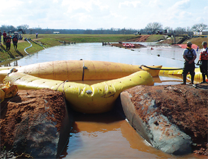 In the arch and PLUG combination, flow is first stopped by floating in the incompressible tube, and the arch then is settled around it to create a cofferdam. PLUG can then be removed and repairs made.