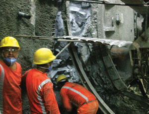 Los Olmos tunnel workers dig out TBM damaged by shifting rock in April.